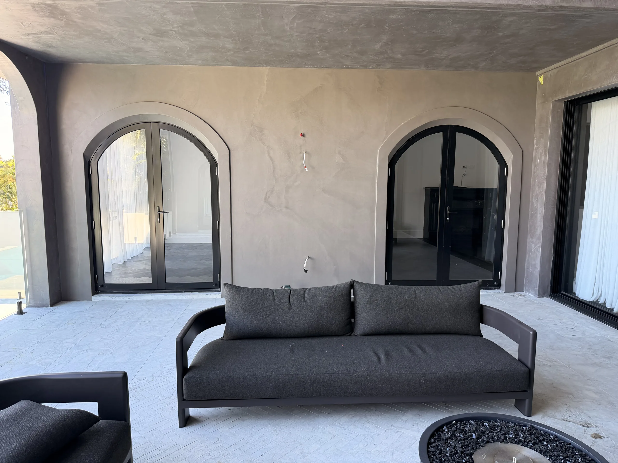 Polished plaster alfresco walls and ceiling with arched doorways