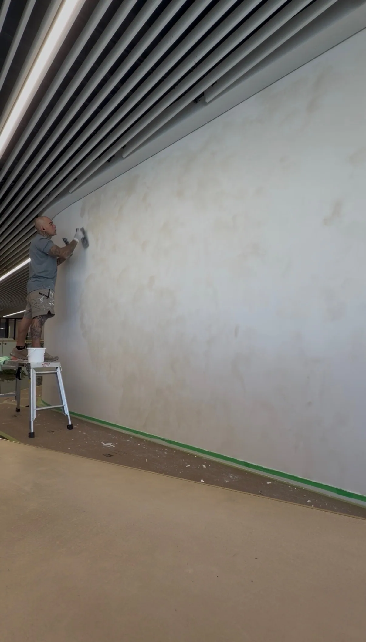 Marmorino being trowelled onto a long feature wall by hand