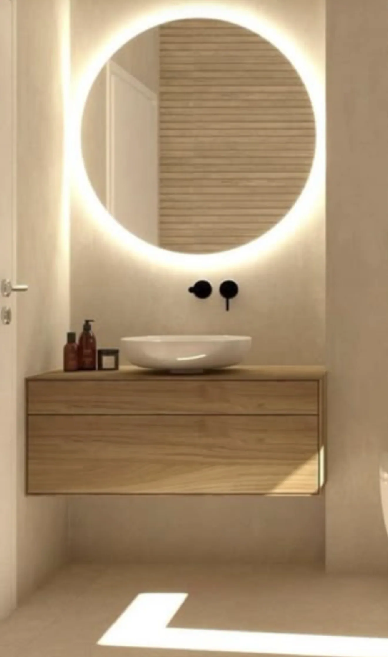 Micro cement bathroom with a backlit round mirror and floating timber vanity