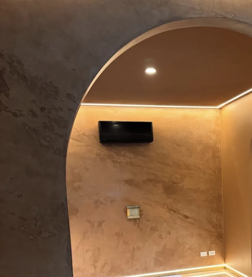 Bronze micro cement archway with concealed cove lighting