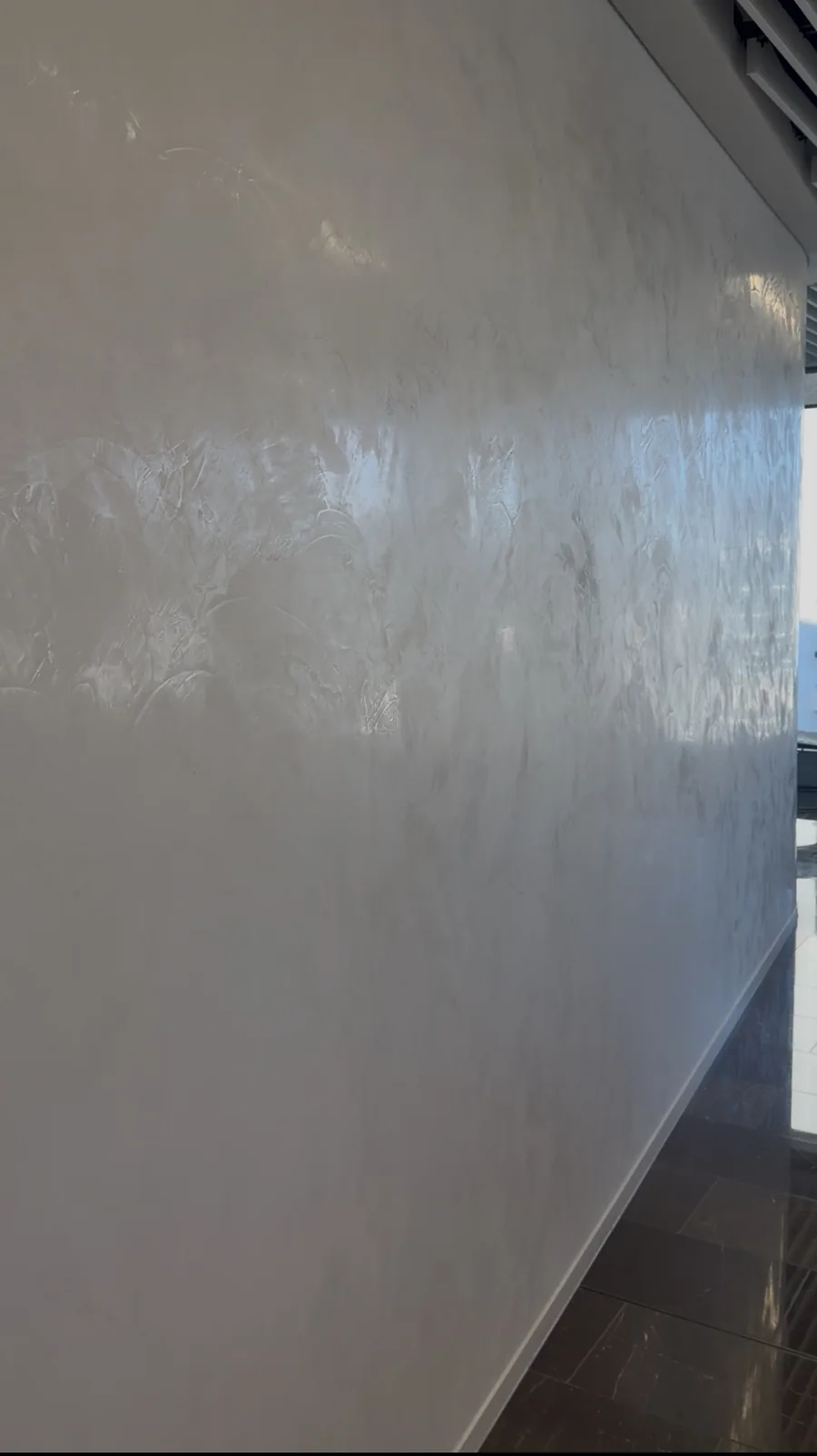Pale polished Venetian plaster wall with a high sheen finish