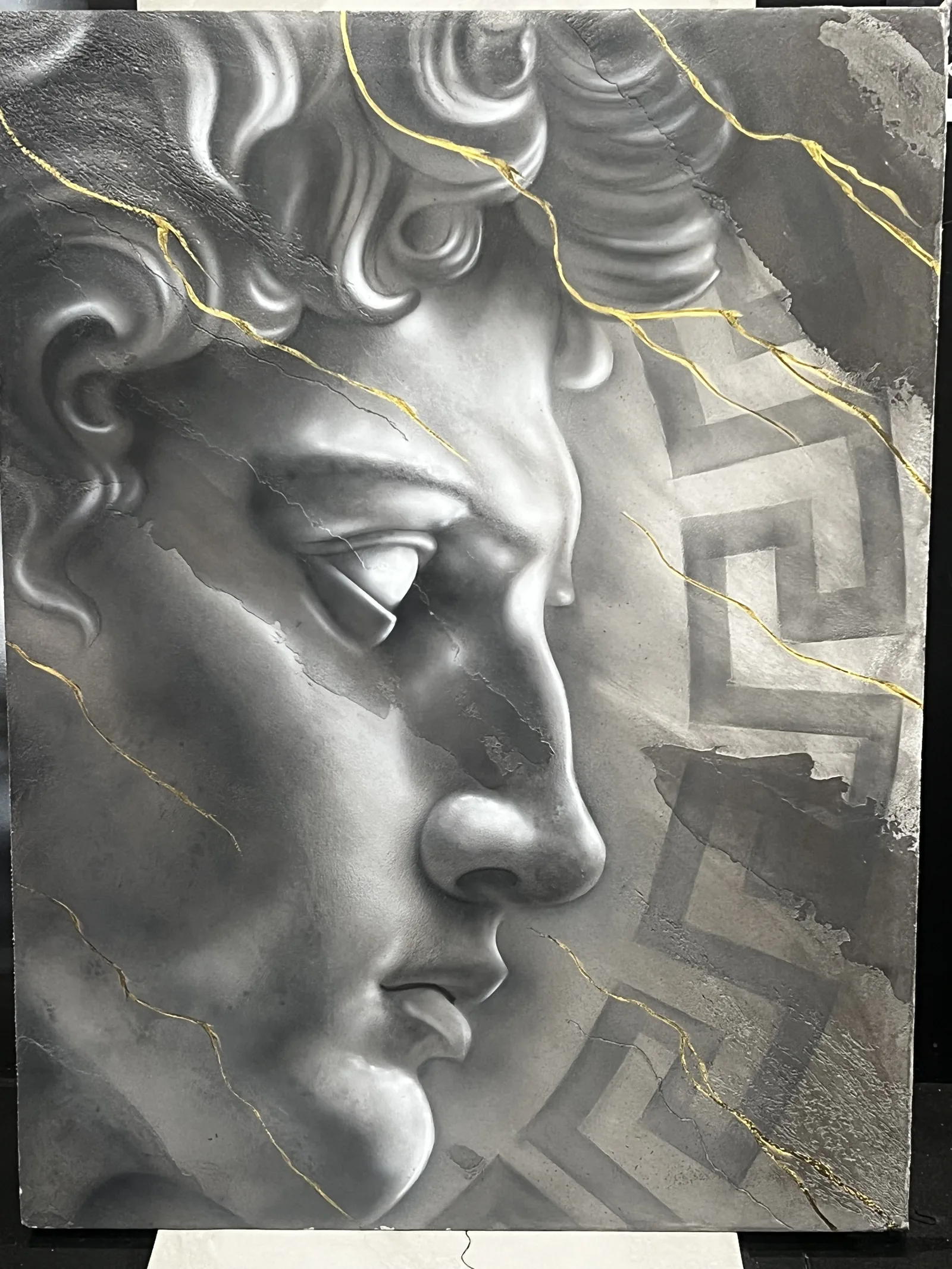 Hand-sculpted classical Greek relief in plaster with gold veining over a Greek key pattern