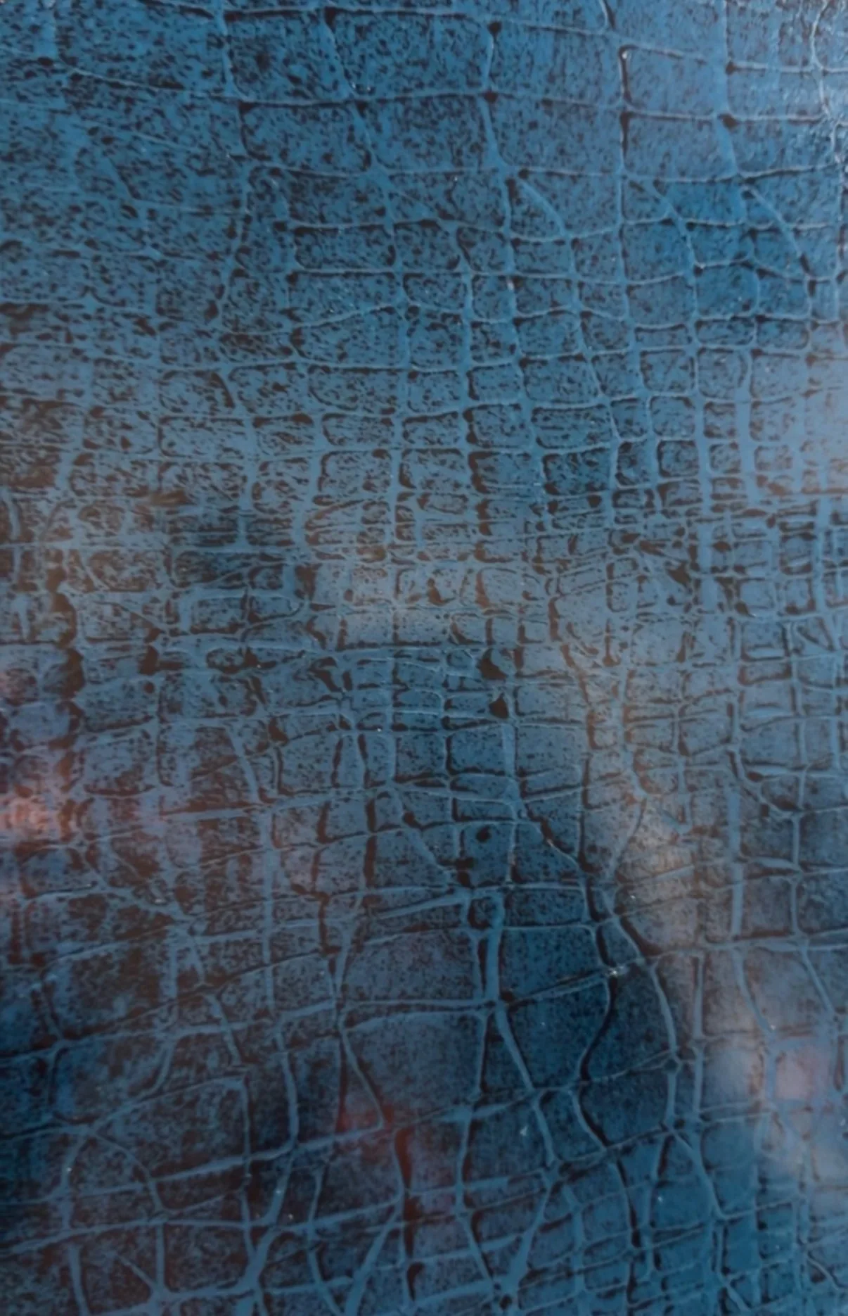Polished crocodile skin and stone texture in deep blue and rust